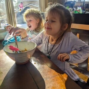 Two young girls eating and enjoying our pineapple fried rice recipe.