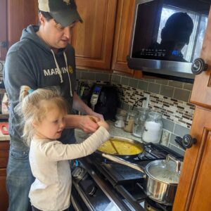 Child helping to cook quick and easy mango curry recipe on stovetop