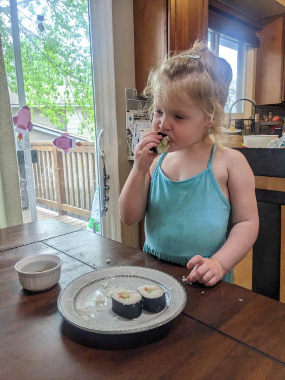Taking her first every bite of sushi from these tasty Zesty California Rolls. And it's a hit featuring this basic sushi rice recipe.